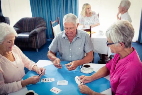 depositphotos 110795912 stock photo group of seniors playing cards